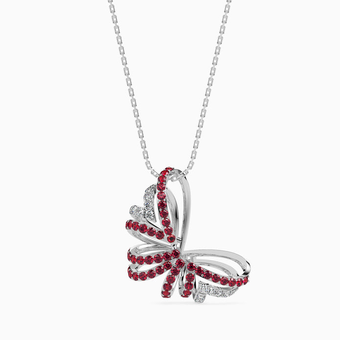 Butterfly-shaped pendant with red stones on a white background
